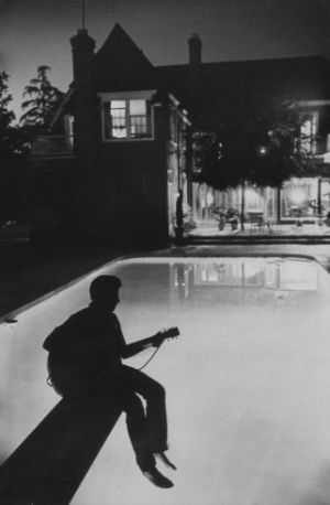17-year-old Ricky Nelson plays guitar in the backyard of the Nelson family Hollywood home in 1958